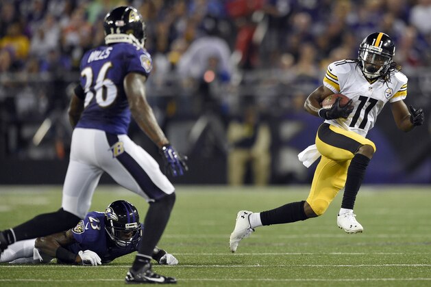 Pittsburgh Steelers wide receiver Markus Wheaton (11) runs away from Baltimore Ravens defensive back Chykie Brown (23), but strong safety Jeromy Miles (36) is waiting, during the first half of an NFL football game Thursday, Sept. 11, 2014, in Baltimore. (AP Photo/Nick Wass)