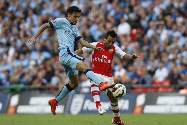Arsenal's Santi Cazorla, right, competes for the ball with Manchester City's Jesus Navas during their English Community Shield soccer match at Wembley Stadium in London, Sunday, Aug. 10, 2014. (AP Photo/Sang Tan) Arsenal's Santi Cazorla, right, competes for the ball with Manchester City's Jesus Navas during their English Community Shield soccer match at Wembley Stadium in London, Sunday, Aug. 10, 2014. (AP Photo/Sang Tan)
