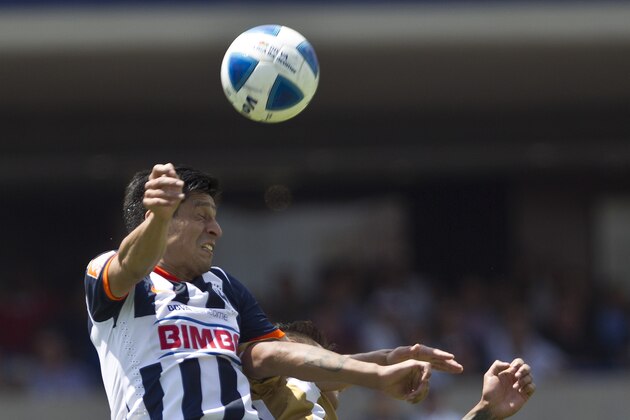 Monterrey's , Ricardo Osorio, left, heads for the ball with Pumas' Ismael Sosa during a Mexican soccer league match in Mexico City, Sunday, March  23, 2014. (AP Photo/Christian Palma)