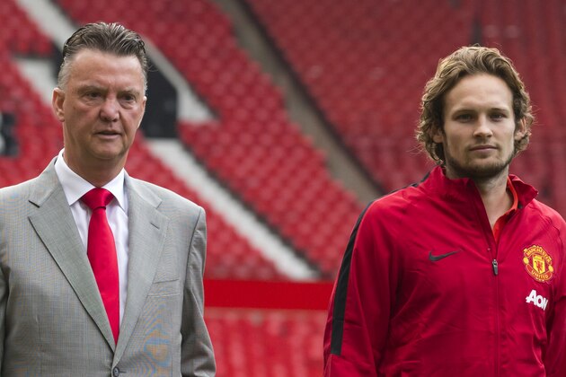 Manchester United's new player Daley Blind, right, walks across the pitch with manager Louis van Gaal at Old Trafford Stadium, Manchester, England, Thursday Sept. 11, 2014. Blind signed from Ajax as Louis van Gaal looks to bolster his attacking options. (AP Photo/Jon Super)
