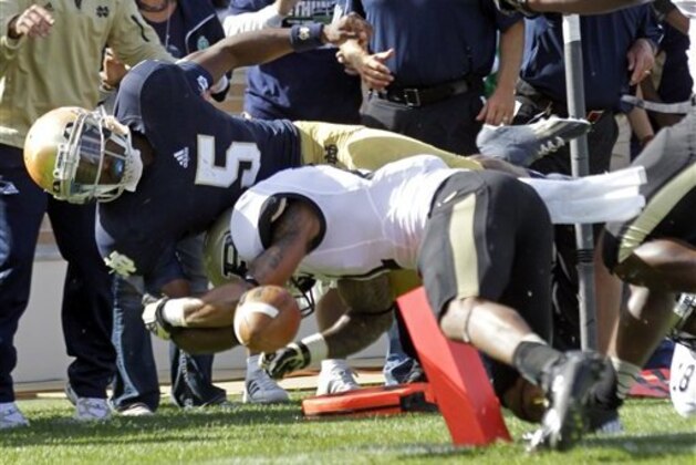 Notre Dame quarterback Everett Golson, left, scores a touchdown as he's hit by Purdue cornerback Ricardo Allen during the first half of an NCAA college football game in South Bend, Ind., Saturday, Sept. 8, 2012. (AP Photo/Michael Conroy)