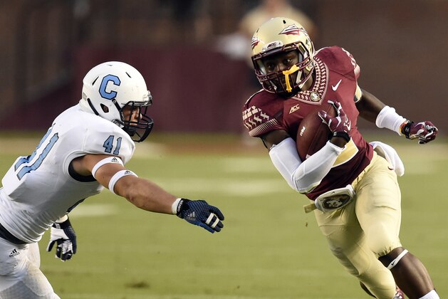 Sep 6, 2014; Tallahassee, FL, USA;  Florida State Seminoles wide receiver Kermit Whitfield (8) carries  against Citadel Bulldogs defensive back Walker Smith (41) during the first quarter at Doak Campbell Stadium. Mandatory Credit: John David Mercer-USA TODAY Sports