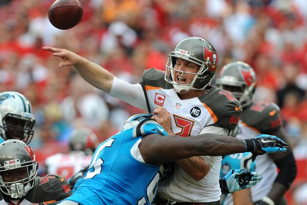 TAMPA, FL - SEPTEMBER 7:  Quarterback Josh McCown #12 is hit by defensive end Charles Johnson #95 of the Carolina Panthers of the Tampa Bay Buccaneers in the third quarter at Raymond James Stadium on September 7, 2014 in Tampa, Florida. McCown threw an interception on the play. (Photo by Cliff McBride/Getty Images)