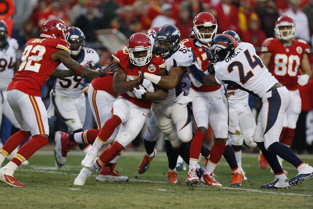 Denver Broncos middle linebacker Wesley Woodyard (52) tries to tackle Kansas City Chiefs running back Jamaal Charles (25) during the first half of an NFL football game, Sunday, Dec. 1, 2013, in Kansas City, Mo. (AP Photo/Ed Zurga)