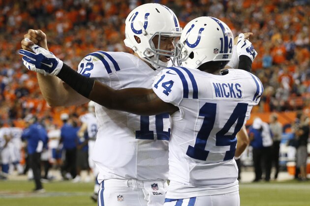 Indianapolis Colts wide receiver Hakeem Nicks (14) celebrates his touchdown with quarterback Andrew Luck (12) during the second half of an NFL football game against the Denver Broncos, Sunday, Sept. 7, 2014, in Denver. (AP Photo/Brennan Linsley)