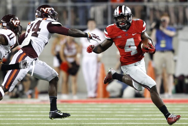 Ohio State running back Curtis Samuel (4) tries to get around Virginia Tech rover Kyshoen Jarrett (34) and cornerback Kendall Fuller (11) during an NCAA college football game Saturday, Sept. 6, 2014, in Columbus, Ohio. Virginia Tech won 35-21. (AP Photo/Paul Vernon)