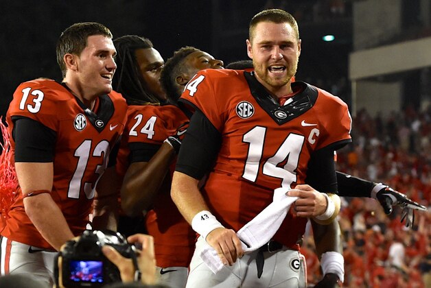 Aug 30, 2014; Athens, GA, USA; Georgia Bulldogs quarterback Hutson Mason (14) and team mates celebrate with the fans after defeating the Clemson Tigers at Sanford Stadium. Georgia defeated Clemson 45-21. Mandatory Credit: Dale Zanine-USA TODAY Sports