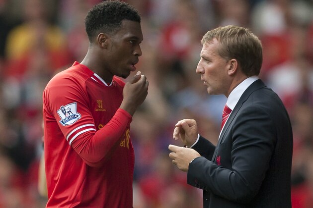 Liverpool's manager Brendan Rodgers, right, briefs striker Daniel Sturridge as the team are beaten 1-0 by Southampton during their English Premier League soccer match at Anfield Stadium, Liverpool, England, Saturday Sept. 21, 2013. (AP Photo/Jon Super)