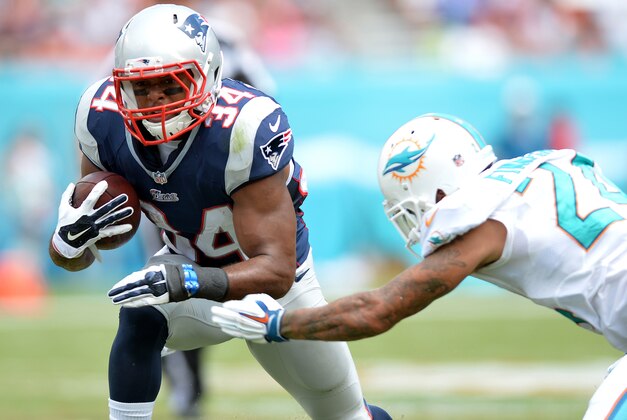Sep 7, 2014; Miami Gardens, FL, USA; New England Patriots running back Shane Vereen (34) is tackled by Miami Dolphins cornerback Cortland Finnegan (24) during the first half at Sun Life Stadium. Mandatory Credit: Steve Mitchell-USA TODAY Sports