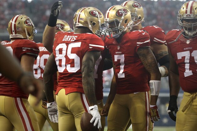 San Francisco 49ers tight end Vernon Davis (85) and Colin Kaepernick (7) celebrate a touchdown catch by Davis in the first half of an NFL football game against the Dallas Cowboys, Sunday, Sept. 7, 2014, in Arlington, Texas.  Kaepernick threw two touchdown passes to Davis, one right after the first of three interceptions by Tony Romo, and the 49ers opened the season with a 28-17 win over the sloppy Cowboys on Sunday. (AP Photo/LM Otero)