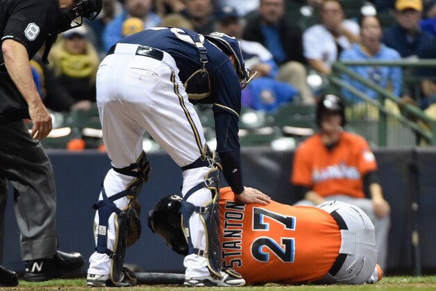 Sep 11, 2014; Milwaukee, WI, USA;  Milwaukee Brewers catcher Jonathan Lucroy (20) checks on Miami Marlins right fielder Giancarlo Stanton (27) after Stanton was hit by a ball in the fifth inning at Miller Park. Mandatory Credit: Benny Sieu-USA TODAY Sports