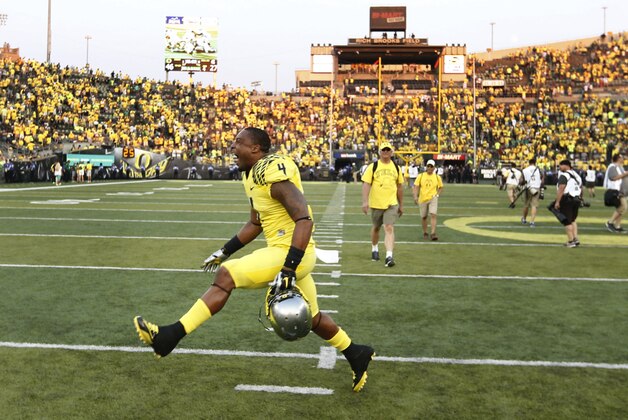 Oregon's Erick Dargan, center, dances across the field after the Ducks defeated the Michigan State Spartans 46 -27 in a college football game in Eugene, OR. Saturday Sept. 6, 2014. (AP Photo/Chris Pietsch)