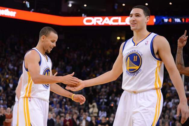 December 3, 2013; Oakland, CA, USA; Golden State Warriors point guard Stephen Curry (30, left) and shooting guard Klay Thompson (11) celebrate during the fourth quarter against the Toronto Raptors at Oracle Arena. The Warriors defeated the Raptors 112-103. Mandatory Credit: Kyle Terada-USA TODAY Sports