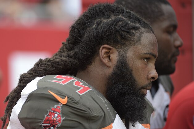 Tampa Bay Buccaneers defensive end Adrian Clayborn (94) watches from the bench during the second half of an NFL football game against the Carolina Panthers in Tampa, Fla., Sunday, Sept. 7, 2014.(AP Photo/Phelan M. Ebenhack)