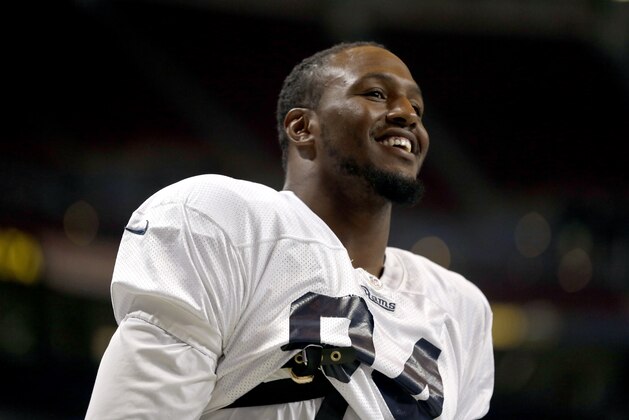 St. Louis Rams defensive end Robert Quinn smiles at the start of practice during NFL football training camp at Edward Jones Dome Saturday, Aug. 2, 2014, in St. Louis. (AP Photo/Jeff Roberson)