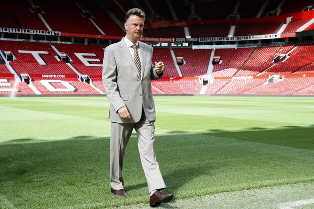 Manchester United's Louis van Gaal walks off the pitch following a photocall for his new player Angel di Maria, at Man. Utd's Old Trafford Stadium in Manchester, England, Thursday, Aug. 28, 2014. Manchester United have signed winger Angel Di Maria from Real Madrid for a British record transfer fee of £59.7 m. The Argentine winger had a medical in Manchester on Tuesday and has signed a five-year deal. Di Maria is likely to make his debut on Saturday against Burnley in the Premier League. (AP Photo/Alastair Grant)