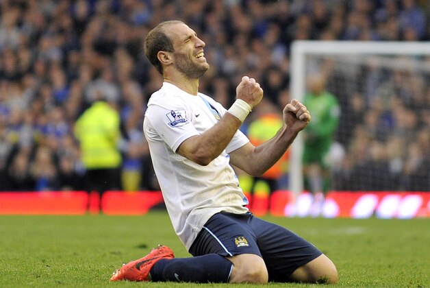 Manchester City's Pablo Zabaleta celebrates their win at the end of their English Premier League soccer match against Everton at Goodison Park in Liverpool, England, Saturday May 3, 2014. (AP Photo/Clint Hughes)