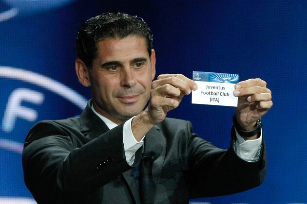 Former Real madrid captain Fernando Hierro, shows the name of Juventus F.C. , who will play Group A,  during the UEFA Champions League draw at the Grimaldi Forum, in Monaco, Thursday, Aug. 28, 2014. (AP Photo/Claude Paris)