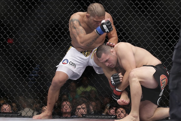 Cain Velasquez, right, tries to take down Antonio Silva in the first round of the UFC 160 mixed martial arts heavyweight title bout, Saturday, May 25, 2013, in Las Vegas. Velasquez won by technical knockout in the first round. (AP Photo/Julie Jacobson)