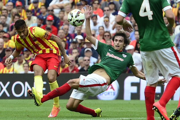 FC Barcelona's Neymar, from Brazil, left, duels for the ball with Athletic Bilbao's Ander Iturraspe during a Spanish La Liga soccer match at the Camp Nou stadium in Barcelona, Spain, Saturday, Sept. 13, 2014. (AP Photo/Manu Fernandez)