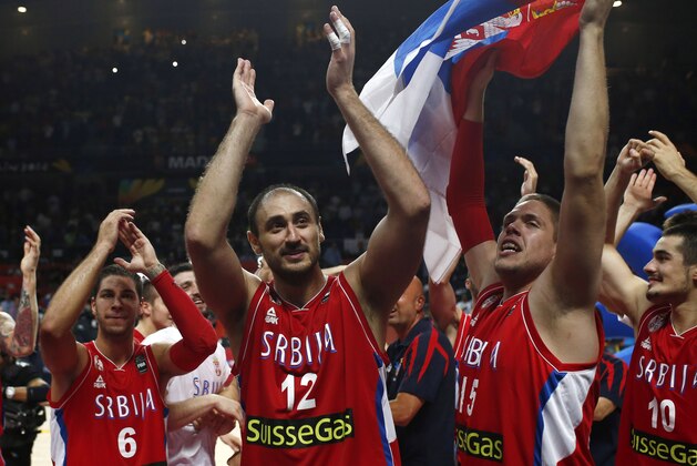 Serbian players celebrate at the end of the Basketball World Cup semifinal between Serbia and France in Madrid, Spain, Friday, Sept. 12, 2014. The 2014 Basketball World Cup competition will take place in various cities in Spain from Aug. 30 through to Sept. 14. Serbia won 90-85 and will play the U.S.A. in the final on Sunday. (AP Photo/Andres Kudacki)