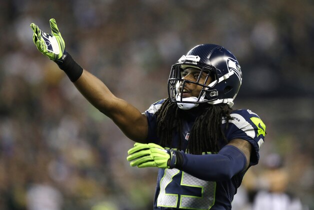 Seattle Seahawks cornerback Richard Sherman gestures to the crowd in the second half of an NFL football game against the Green Bay Packers, Thursday, Sept. 4, 2014, in Seattle. The Seahawks won 36-16. (AP Photo/Scott Eklund)