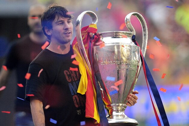 FC Barcelona's Lionel Messi holds the trophy after winning the Champions League soccer title at the Camp Nou stadium in Barcelona city, Sunday, May 29, 2011. (AP Photo/Manu Fernandez)