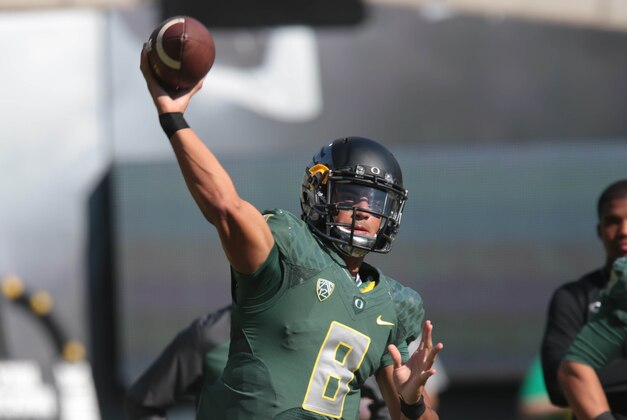Sep 13, 2014; Eugene, OR, USA; Oregon Ducks quarterback Marcus Mariota (8) throws the ball before the game against the Wyoming Cowboys at Autzen Stadium. Mandatory Credit: Scott Olmos-USA TODAY Sports