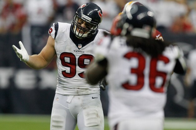 HOUSTON, TX - SEPTEMBER 07:  J.J. Watt #99 of the Houston Texans gestures to D.J. Swearinger #36 after he deflected a pass that Swearinger almost intercepted at Reliant Stadium on September 7, 2014 in Houston, Texas.  (Photo by Bob Levey/Getty Images)