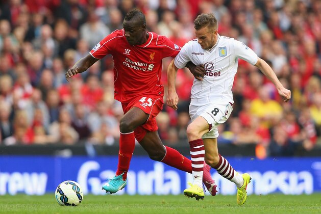 LIVERPOOL, ENGLAND - SEPTEMBER 13:  Mario Balotelli of Liverpool goes past Tom Cleverley of Aston Villa during the Barclays Premier League match between Liverpool and Aston Villa at Anfield on September 13, 2014 in Liverpool, England.  (Photo by Alex Livesey/Getty Images)
