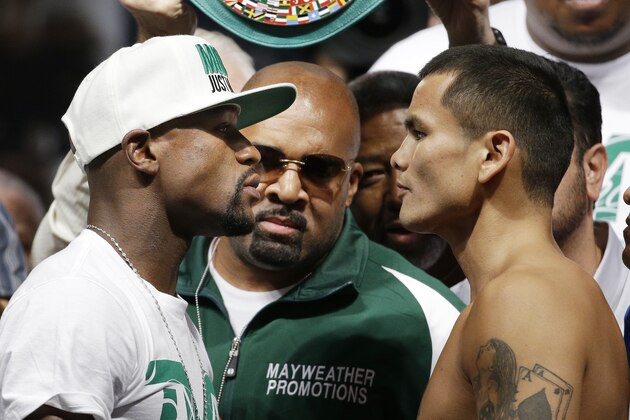 Floyd Mayweather Jr., left, and Marcos Maidana pose during a weigh-in Friday, Sept. 12, 2014, in Las Vegas. The two are scheduled to fight in a welterweight title boxing bout Saturday in Las Vegas. (AP Photo/John Locher)