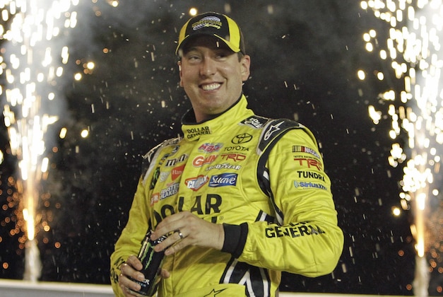 Kyle Busch stands in Victory Circle after winning the NASCAR truck series auto race at Kentucky Speedway in Sparta, Ky., Thursday June 26, 2014.  (AP Photo/Garry Jones)