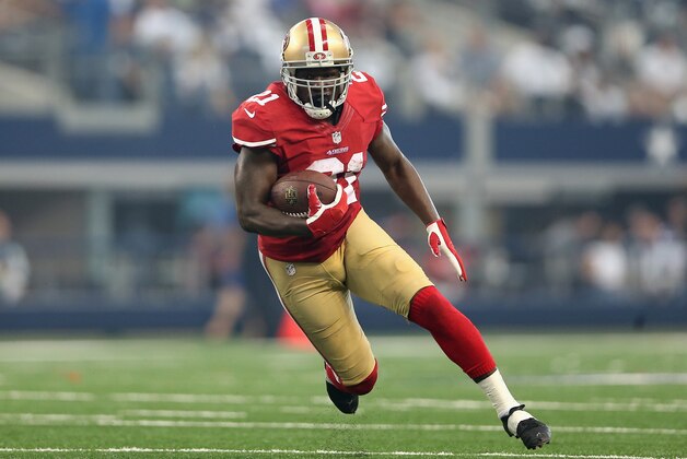 ARLINGTON, TX - SEPTEMBER 07:  Running back Frank Gore #21 of the San Francisco 49ers rushes the football against the Dallas Cowboys during the NFL game at AT&T Stadium on September 7, 2014 in Arlington, Texas. The 49ers defeated the Cowboys 28-17.  (Photo by Christian Petersen/Getty Images)