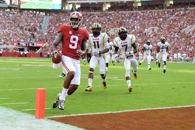 Sep 13, 2014; Tuscaloosa, AL, USA;  Alabama Crimson Tide wide receiver Amari Cooper (9) jogs into the end zone for a touchdown against the Southern Miss Golden Eagles during the first quarter at Bryant-Denny Stadium. Mandatory Credit: John David Mercer-USA TODAY Sports