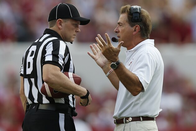 Alabama head coach speaks with a referee in the first half during an NCAA college football game  on Saturday, Sept. 13, 2014, in Tuscaloosa, Ala. (AP Photo/Brynn Anderson)