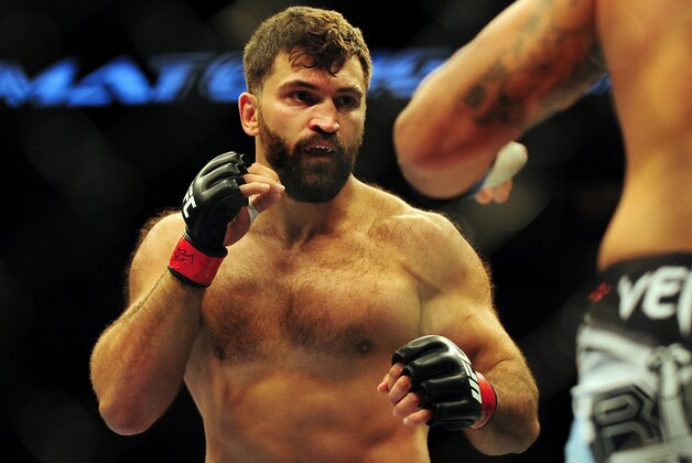 Jun 14, 2014; Vancouver, British Columbia, Canada; Andrei Arlovski (red) fights against Brendan Schuab (blue) in their heavyweight bout for UFC 174 at Rogers Arena. Mandatory Credit: Anne-Marie Sorvin-USA TODAY Sports