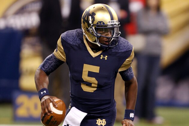 Sep 13, 2014; Indianapolis, IN, USA; Notre Dame Fighting Irish quarterback Everett Golson (5) rolls out of the pocket against the Purdue Boilermakers at Lucas Oil Stadium. Mandatory Credit: Brian Spurlock-USA TODAY Sports