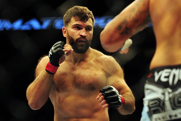 Jun 14, 2014; Vancouver, British Columbia, Canada; Andrei Arlovski (red) fights against Brendan Schuab (blue) in their heavyweight bout for UFC 174 at Rogers Arena. Mandatory Credit: Anne-Marie Sorvin-USA TODAY Sports