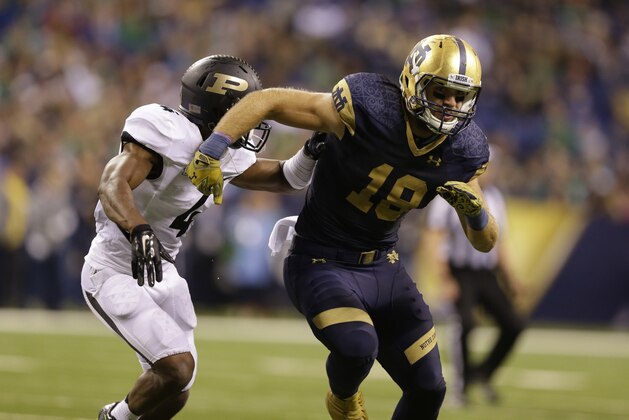 Notre Dame tight end Ben Koyack, right, blocks Purdue safety Taylor Richards  during the second half of an NCAA college football game against Purdue in Indianapolis, Saturday, Sept. 13, 2014. Notre Dame defeated Purdue 30-14. (AP Photo/Michael Conroy)