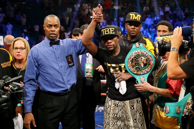 LAS VEGAS, NV - SEPTEMBER 13:  Floyd Mayweather Jr. celebrates his unanimous decision victory against Marcos Maidana during their WBC/WBA welterweight title fight at the MGM Grand Garden Arena on September 13, 2014 in Las Vegas, Nevada.  (Photo by Al Bello/Getty Images)