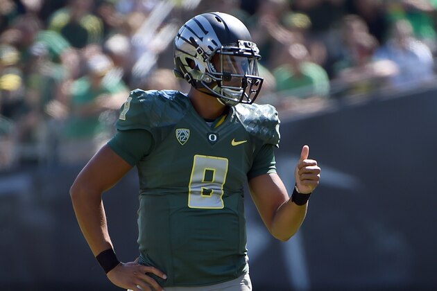 Oregon quarterback Marcus Mariota (8) signals to his teammates during the second quarter of an NCAA college football game against Wyoming at Autzen Stadium on Saturday, Sept. 13, 2014, in Eugene, Ore. (AP Photo/Steve Dykes)