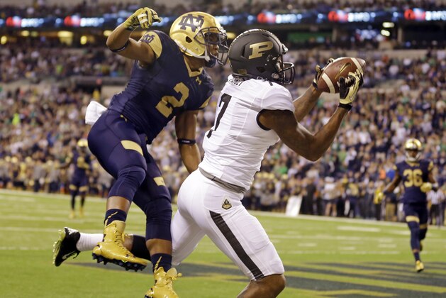 Purdue wide receiver DeAngelo Yancey, right, makes a catch for a touchdown in front of Notre Dame cornerback Cody Riggs during the first half of an NCAA college football game in Indianapolis, Saturday, Sept. 13, 2014. (AP Photo/Michael Conroy)