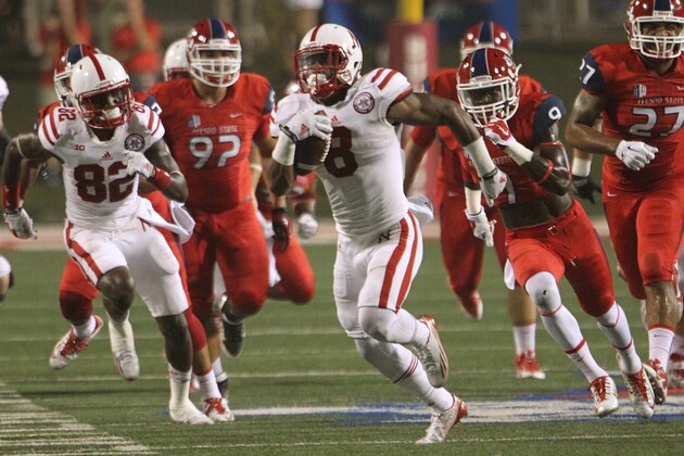 Nebraska's Ameer Abdullah runs through the Fresno State defense on the way to a touchdown in the first half of an NCAA college football game in Fresno, Calif., Saturday, Sept. 13, 2014. (AP Photo/Gary Kazanjian)