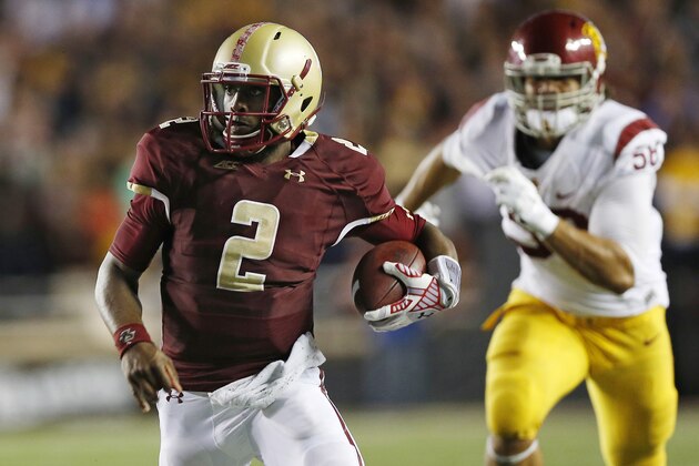BOSTON, MA- SEPTEMBER 13: Quarterback Tyler Murphy #2 of the Boston College Eagles runs past linebacker J.R. Tavai #58 of the USC Trojans during the second half of BC's 37-31 win at Alumni Stadium on September 13 in Chestnut Hill, Massachusetts.  (Photo by Winslow Townson/Getty Images)