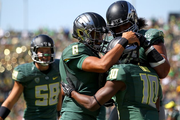 EUGENE, OR - SEPTEMBER 13:  Quarterback Marcus Mariota #8 of the Oregon Ducks celebrates a touchdown pass to Johnathan Loyd #10 against the Wyoming Cowboys at Autzen Stadium on September 13, 2014  in Eugene, Oregon.  (Photo by Jonathan Ferrey/Getty Images)