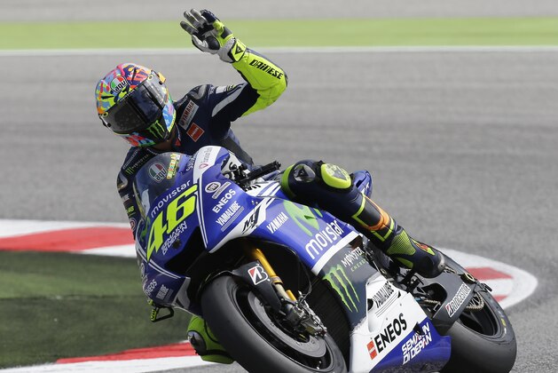Italy's rider Valentino Rossi waves to his fans after a fourth free practice session for Sunday's San Marino Moto GP grand prix at the Misano circuit, in Misano Adriatico, Italy, Saturday, Sept. 13, 2014. (AP Photo/Antonio Calanni)