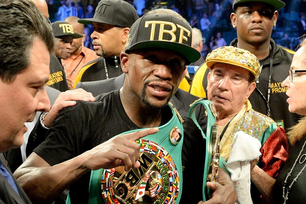 Sep 13, 2014; Las Vegas, NV, USA; Floyd Mayweather celebrates in the ring after defeating Marcos Maidana (not pictured) in their WBC & WBA Welterweight and WBC Superwelter Weight title fight at the MGM Grand Garden Arena. Mandatory Credit: Jayne Kamin-Oncea-USA TODAY Sports