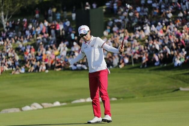 Hyo Joo Kim of South Korea celebrates after finishing the last round to win the Evian Championship women's golf tournament in Evian, eastern France, Sunday, Sept. 14, 2014. (AP Photo/Laurent Cipriani)