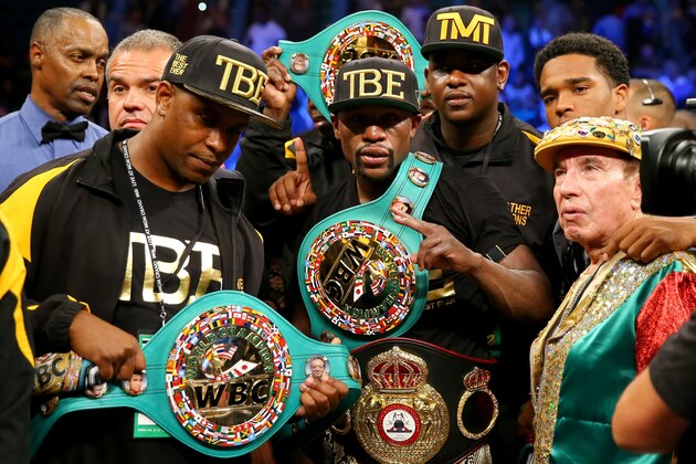 LAS VEGAS, NV - SEPTEMBER 13:  Floyd Mayweather Jr. celebrates his unanimous-decision victory over Marcos Maidana during their WBC/WBA welterweight title fight at the MGM Grand Garden Arena on September 13, 2014 in Las Vegas, Nevada.  (Photo by Al Bello/Getty Images)