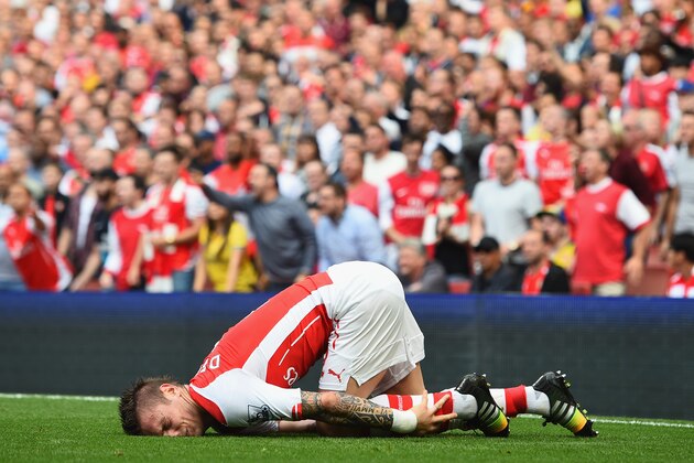 LONDON, ENGLAND - SEPTEMBER 13:  Mathieu Debuchy of Arsenal is injured in the first half during the Barclays Premier League match between Arsenal and Manchester City at Emirates Stadium on September 13, 2014 in London, England.  (Photo by Shaun Botterill/Getty Images)